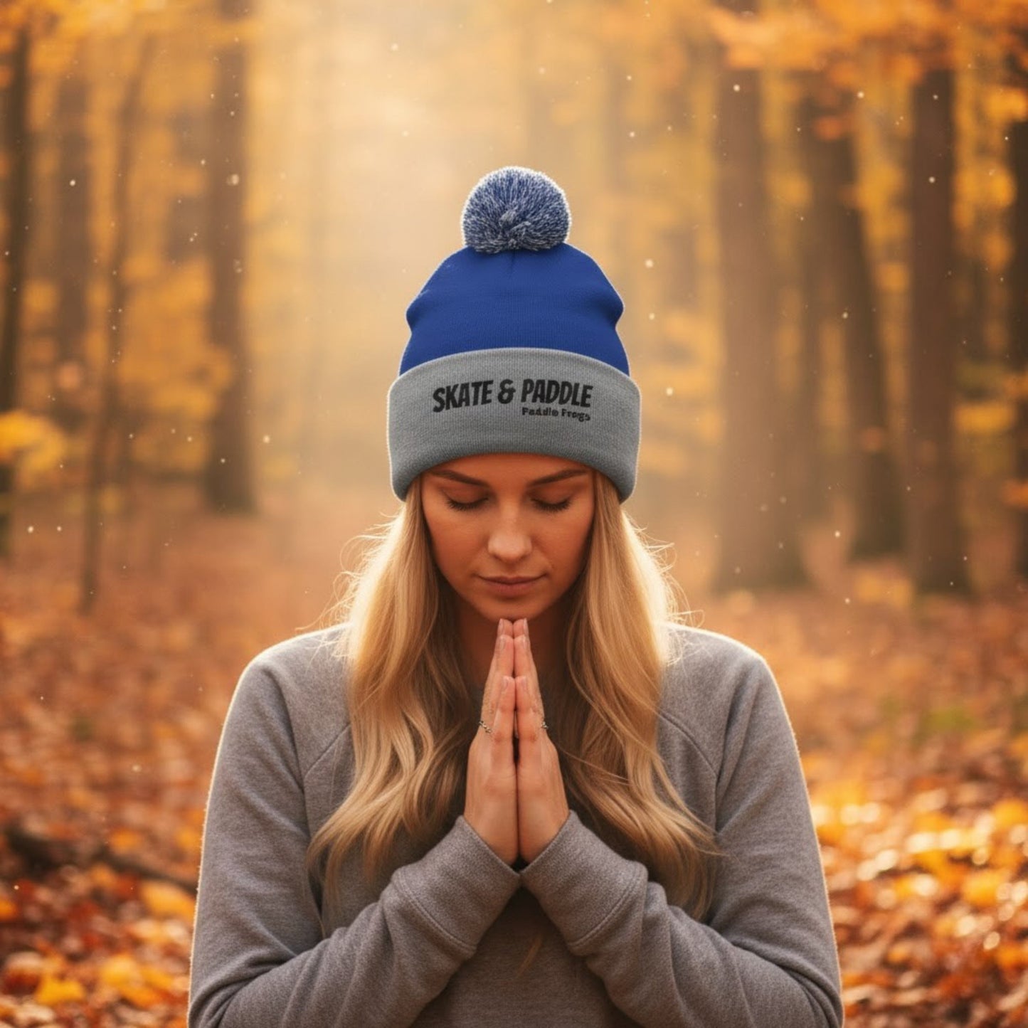 Woman wearing a blue and gray beanie with 'Skate & Paddle' logo in an autumn forest. The Summit & Surf Beanie: A Paddle Frogs Anthem by Paddle Frogs™ Outdoor Gear Skate & Paddle headwear
