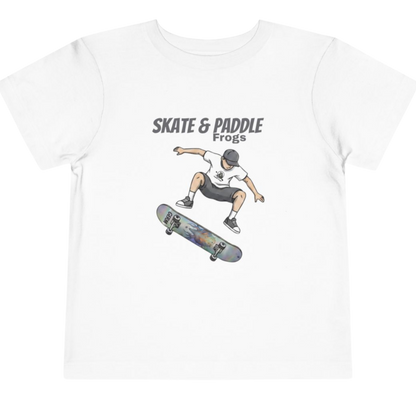 Toddler Skateboard Tee — Germ "Skate & Paddle Frogs™ White on a transparent background