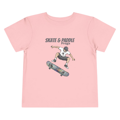 Toddler Skateboard Tee — Germ "Skate & Paddle Frogs™ Pink on a transparent background