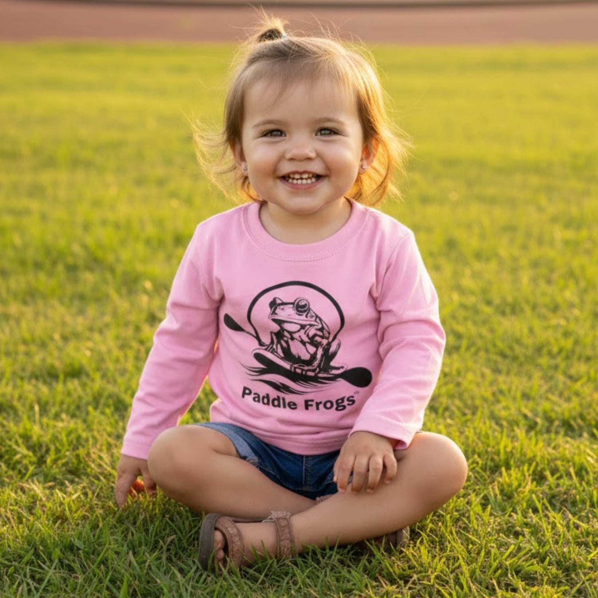 Toddler's in Balance | Long Sleeve Tee | Paddle Frogs™ girl sitting crisscross applesauce wearing Light Pink
