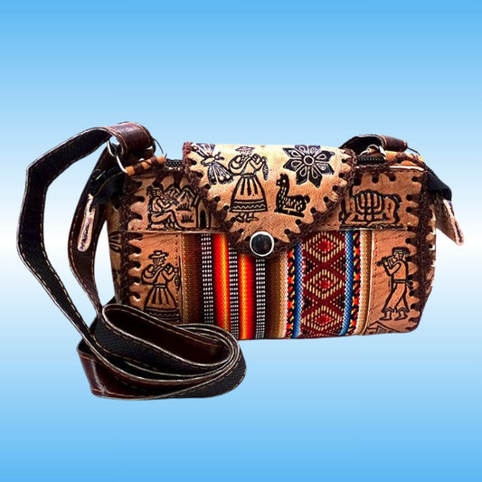A handcrafted leather shoulder bag with a long dark brown strap, featuring a front flap decorated with black hand-drawn indigenous-style figures and geometric patterns, and vertical woven textile panels in red, blue, orange, and black.