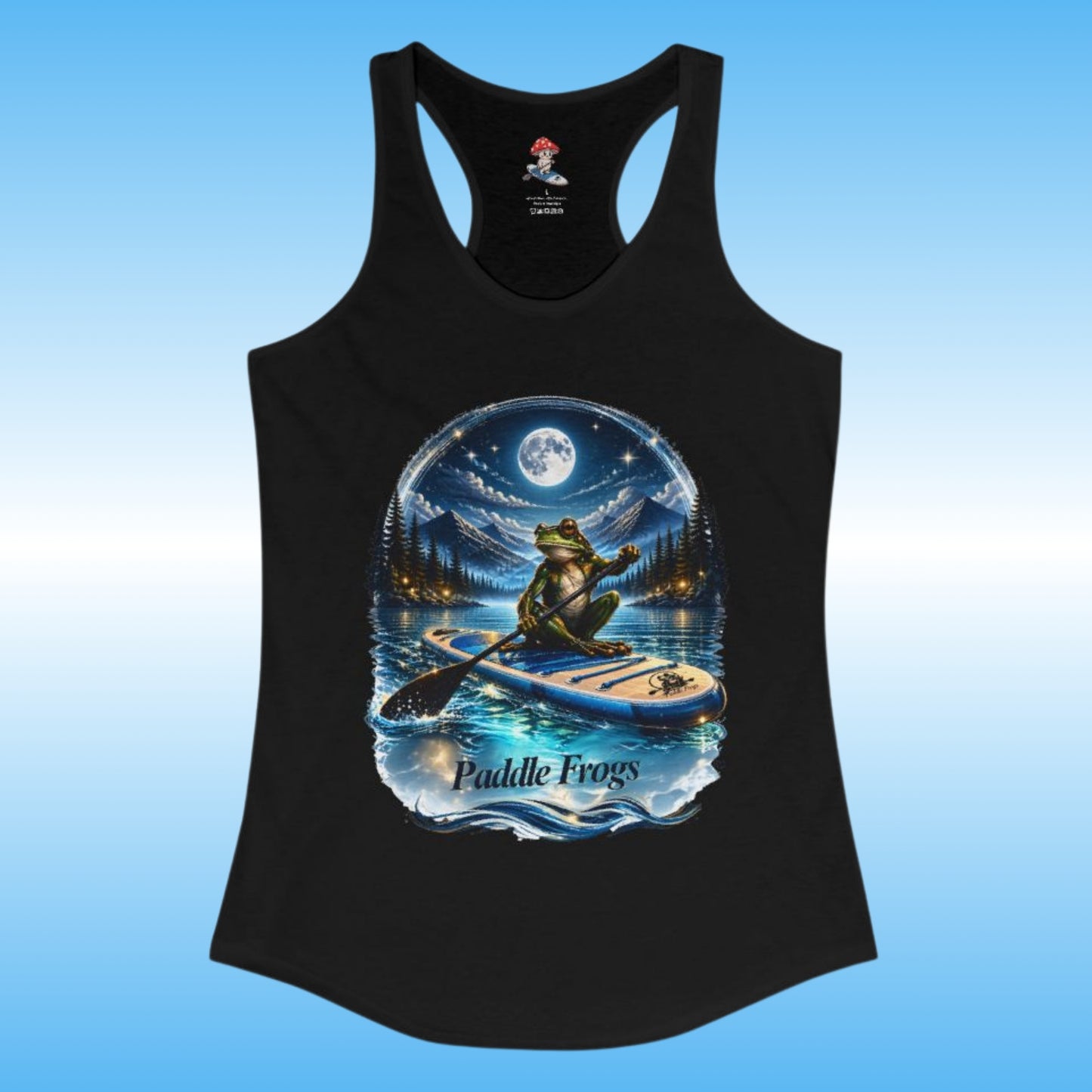 A black racerback tank top featuring a large circular graphic of a frog paddleboarding on water under a full moon, with the text 'Paddle Frogs' printed below the design. The tank top is displayed against a light blue gradient background.