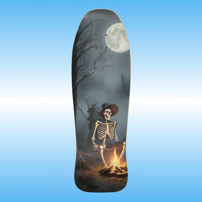 Warm Your Bones - Paddle Frogs  - Skateboard deck with a skeleton by a campfire and moonlit sky design on a blue gradient background.
