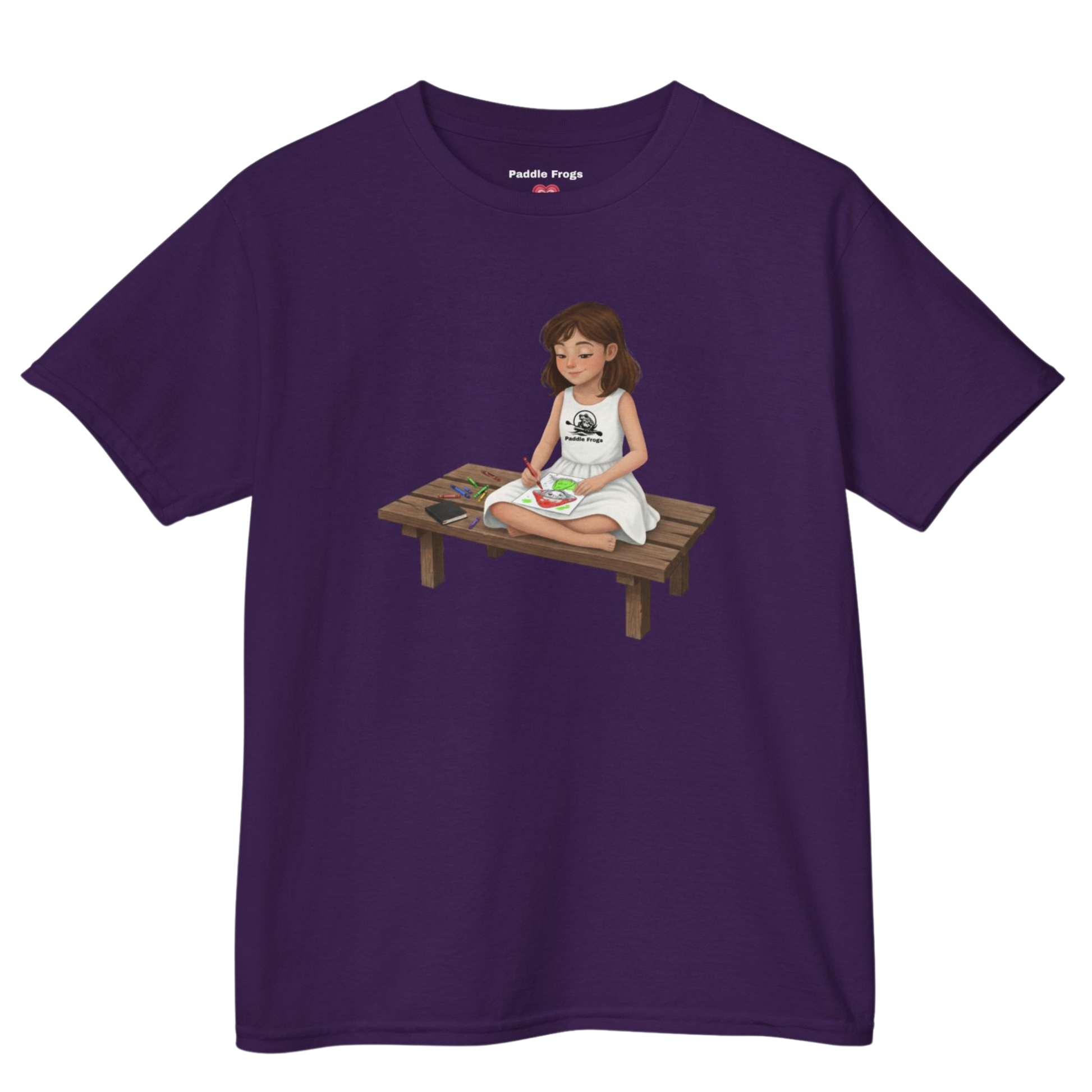 Purple t-shirt with a graphic of a girl named Willow sitting on a wooden table coloring Bailey on a transparent background