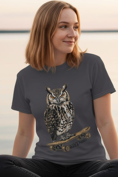 Wise Owl's Skate & Paddle Tee being modeled by a young lady sitting crisscross applesauce by the sea.