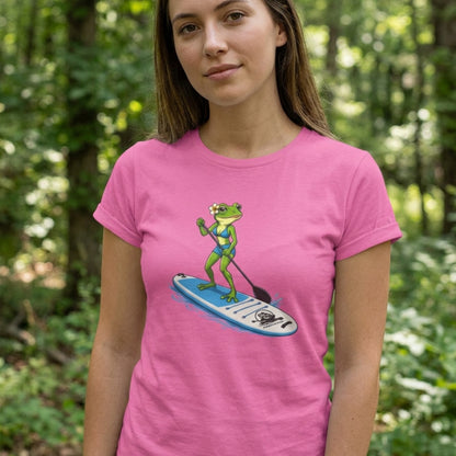 A woman wearing a bright pretty pink stand up paddle board tee with a lady frog paddling. by Paddle Frogs