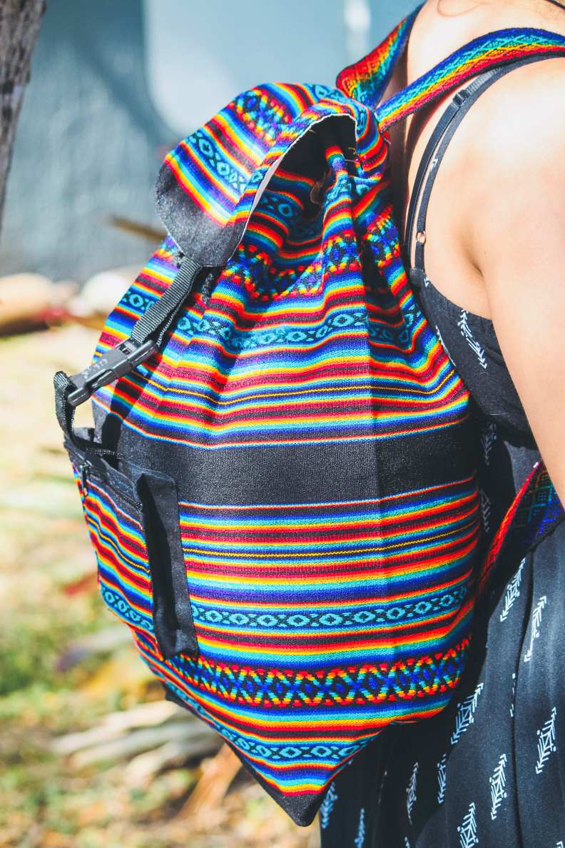 Colorful striped backpack with a blurred natural background