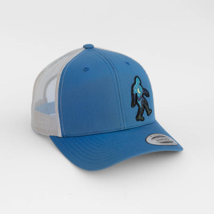 Blue and gray cap with Bigfoot and the night sky on a white background