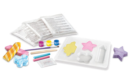Children's chalk craft kit with molds, paint, and other supplies on a white background