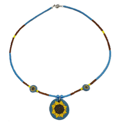 Necklace with sunflower pendant on a white background
