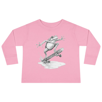 Pink long-sleeve shirt with a frog on a skateboard graphic on a white background