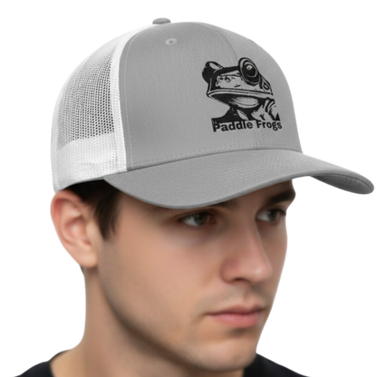 Gray and white cap with a frog logo and 'Paddle Frogs' text worn by a person on a white background