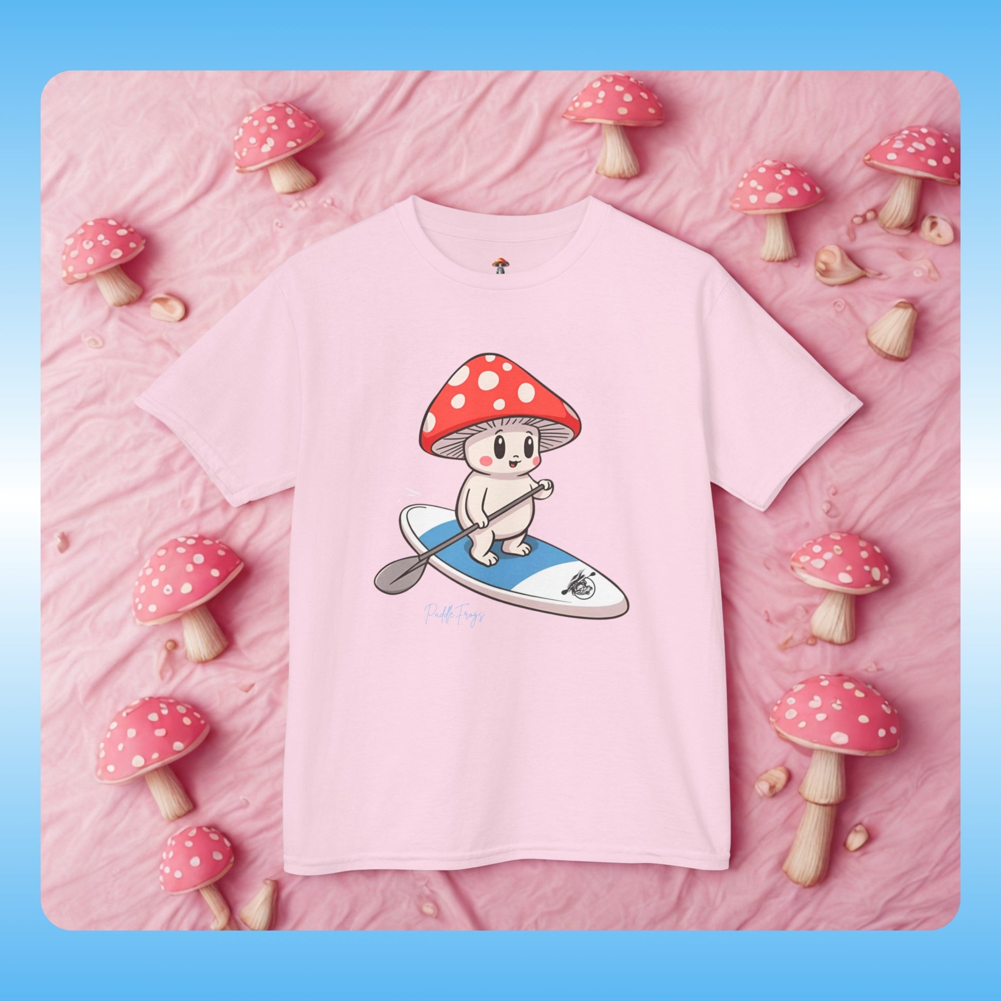 mushroom creature from Mushroom Forest riding the Divine Escape paddle board Youth Tee Shirt Pink | Pink t-shirt with a cartoon character on a pink background with decorative mushrooms