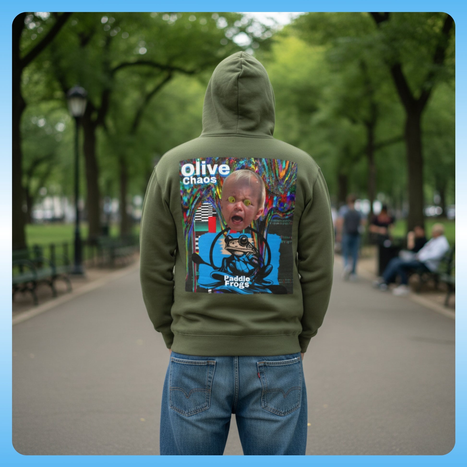 olive Chaos Green Paddle Frogs Outdoor Gear Hoodie pull over coat Person wearing a green hoodie with a colorful graphic on the back in a park setting