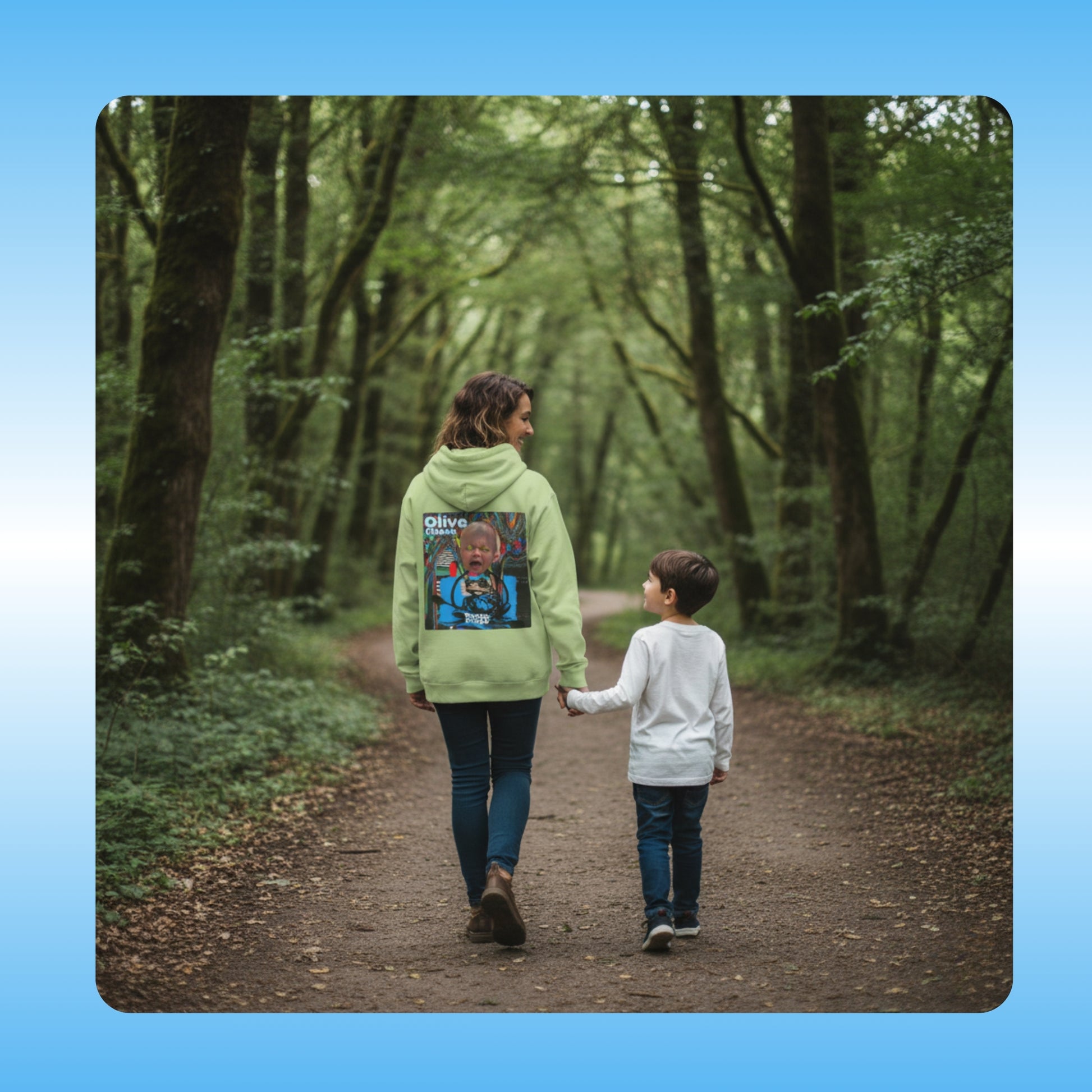 olive Chaos  Paddle Frogs Outdoor Gear Hoodie pull over coat green Two people walking down a path in a forest with a focus on the person in the green jacket with a colorful design.