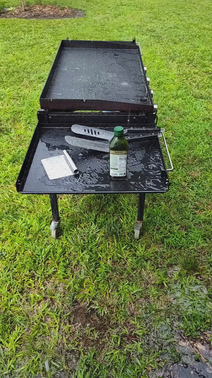 Grilling outside in the rain. Paddle Frogs in Harriman, TN events and Saturday Fun Days at 5pm. Games, sports, paddleboarding, where good people gather to be outside, shop, and have a blast in East Tennessee.