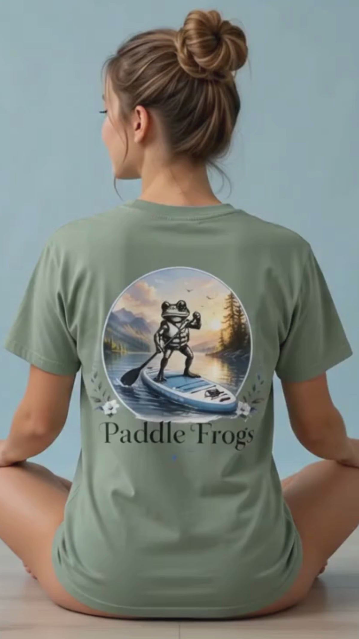 A lady modeling the Paddle Frogs™ Sage cotton paddleboarding tee letting every woman know that it is super soft and comfortable.