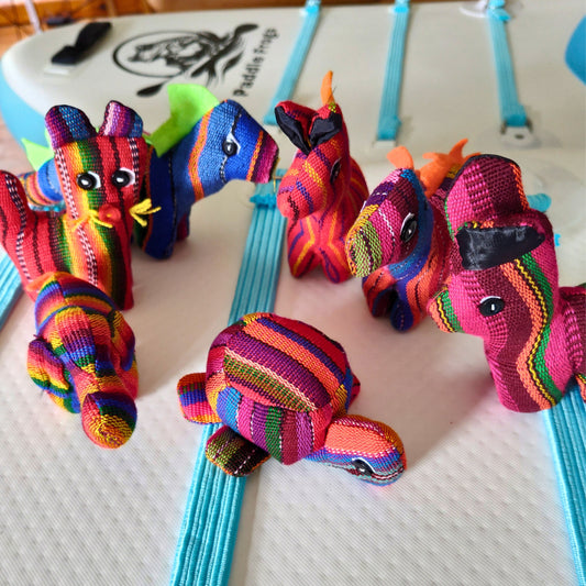 Colorful handcrafted stuffed animal toys on a white surface