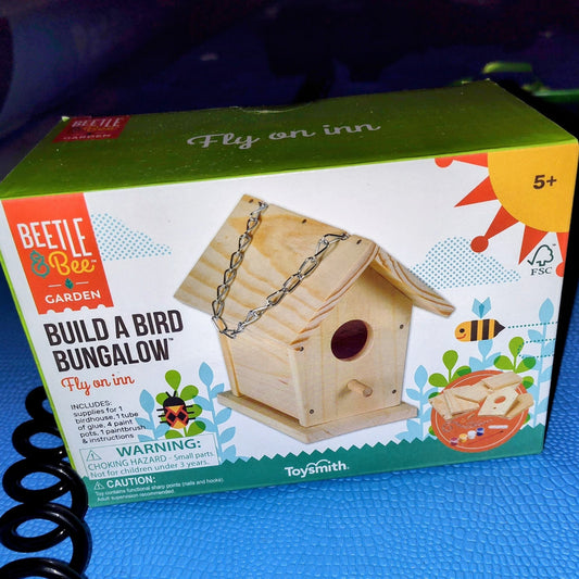 Box for 'Build a Bird Bungalow' kit by Beetle & Bee Garden on a paddleboard at Paddle Frogs agritourism shop in Harriman Tennessee 