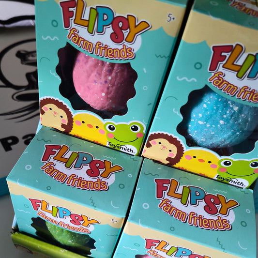 Four boxes of Flipsy farm friends toys with colorful squishy animals inside.