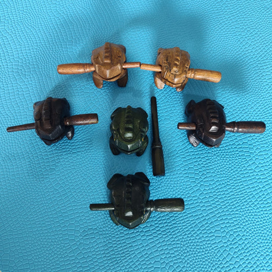 Art hippie frog wooden percussion instruments on a blue textured background