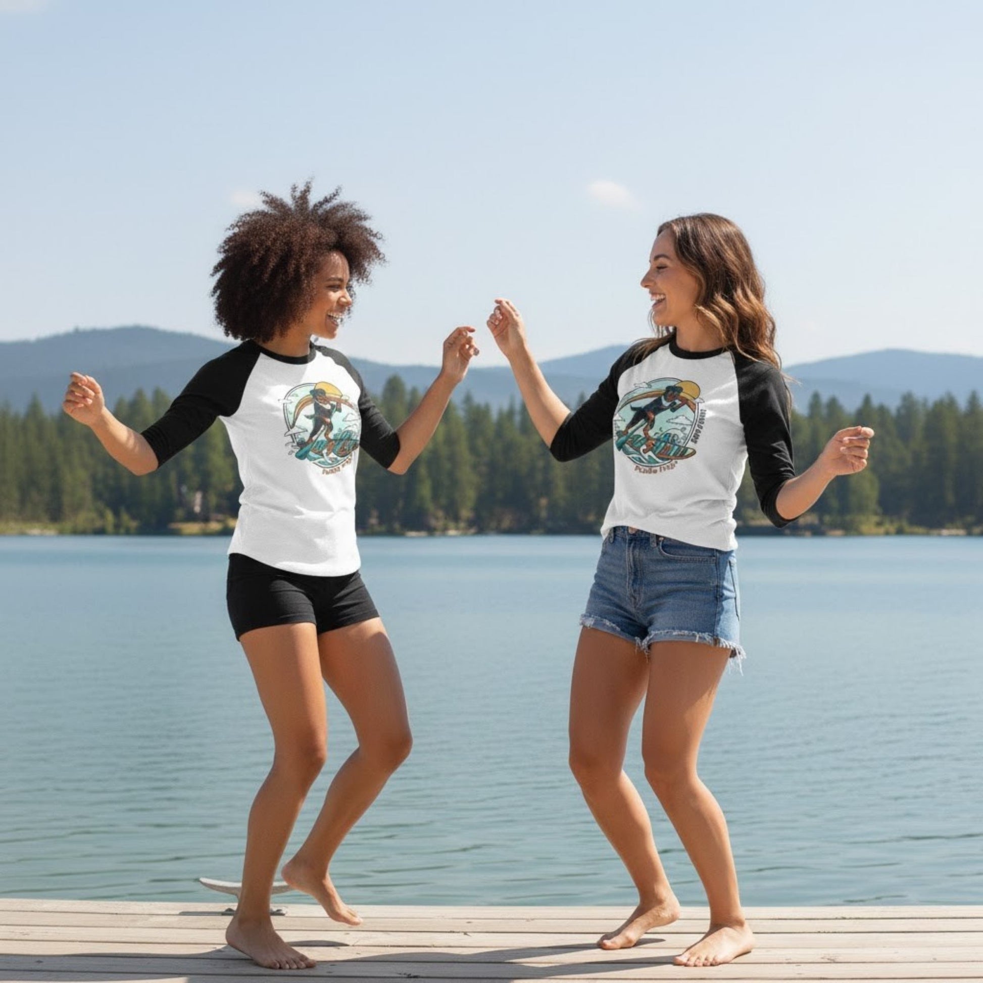 two ladies dancing at the kayak boat dock wearing Rottweiler Paddleboarding tee by Paddle Frogs